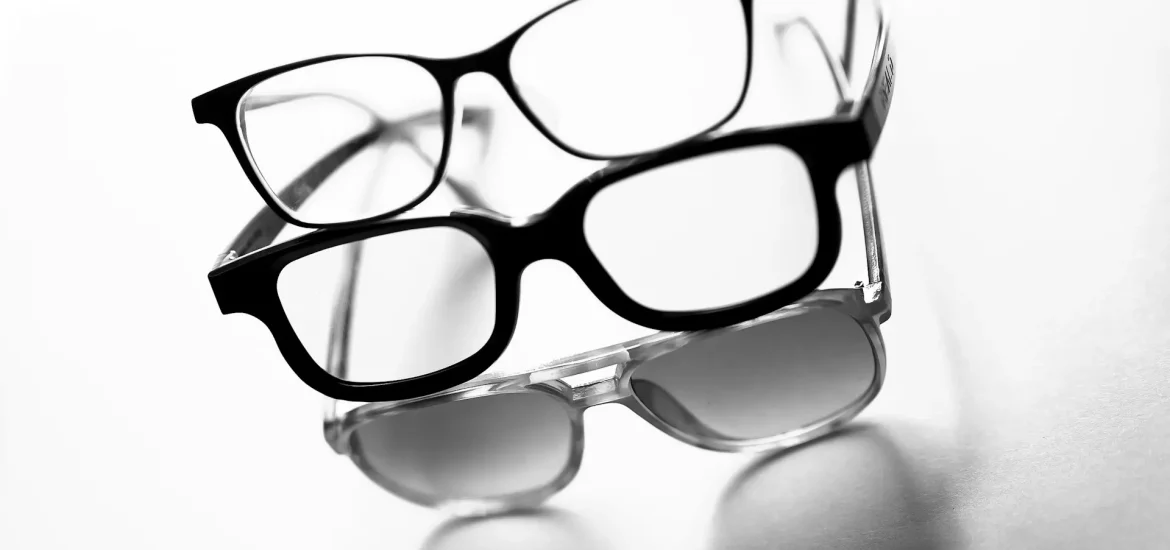 Três óculos pretos com materiais de armação de óculos diferentes